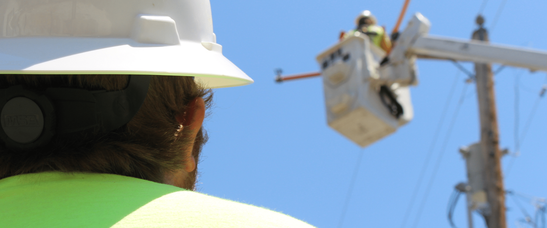 IES employee looking upward on-site, reflecting our commitment to safety and proactive Job Hazard Analysis in every mission critical project.