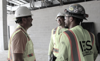 Three IES employees in hardhats and safety glasses