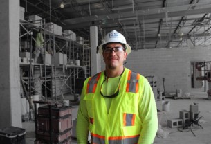 IES technician in safety gear looking into camera