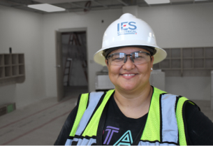 Female IES employee in hardhat smiling