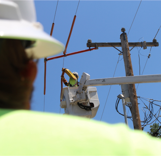 Linemen in cherrypickers working on electrical line