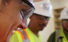 Up close of IES employee and two blurred in background