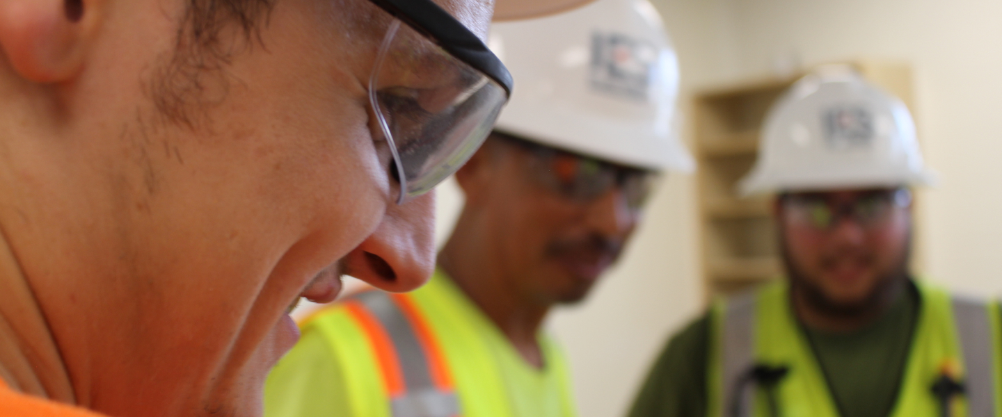 Up close of IES employee and two blurred in background