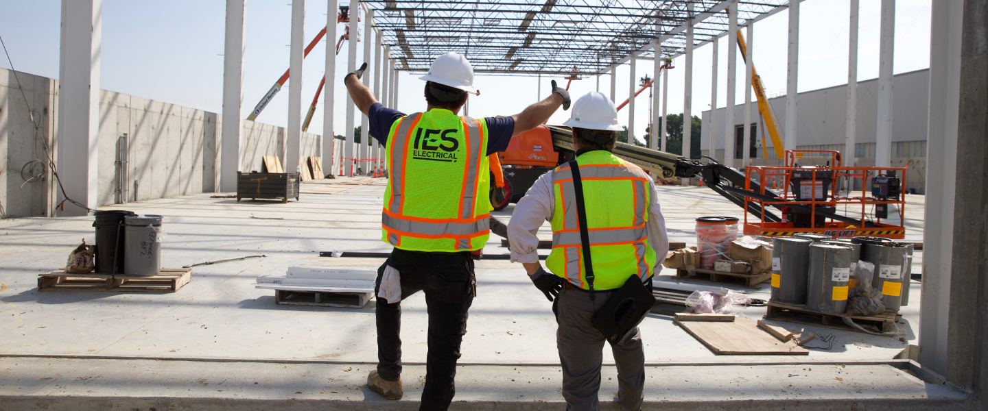 Two IES employees at construction site in safety gear