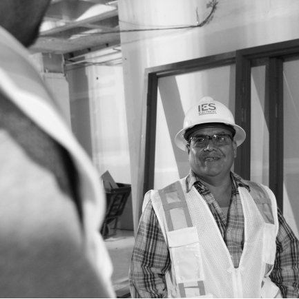 Black and white image of IES employee in safety gear