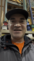 Keynan in hat smiling into camera