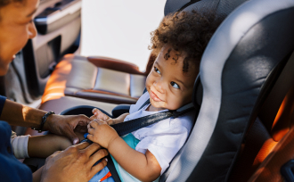 Parent putting child into carseat