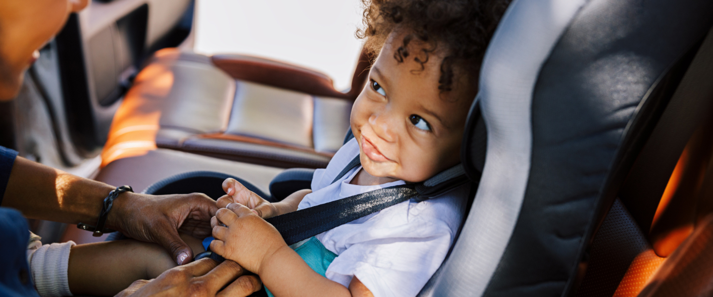 Child in carseat looking at parent
