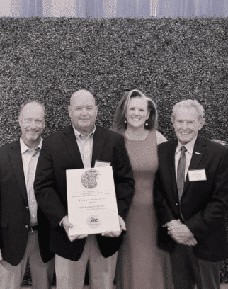 Sepia image of three men and one woman together with one holding an eagle plaque