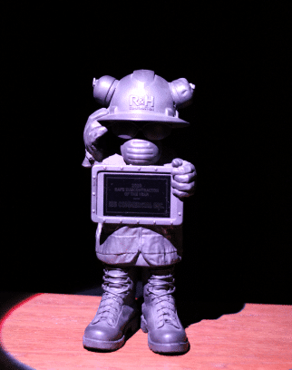Safety award shaped like person in safety gear with hardhat, mask, boots